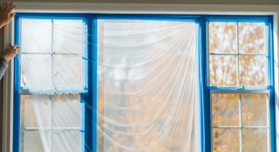Plastic sheeting protects the glass from drips, splatter, and overspray.