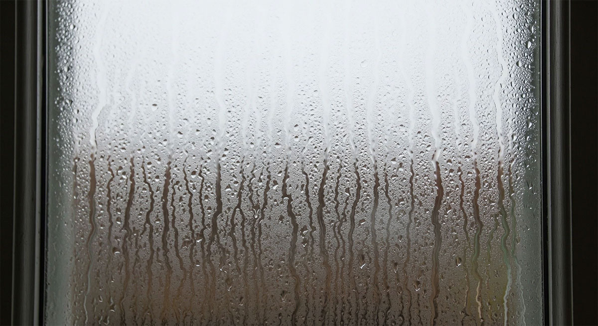 Close up of window with moisture or condensation between glass panes